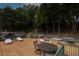 Great wooden deck with plenty of room for outdoor dining and entertaining, with views of the wooded property at 6029 Shadburn Ferry Rd, Buford, GA 30518