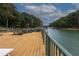 Large outdoor deck with views of the lake, complete with comfortable seating for enjoying the waterfront scenery at 6029 Shadburn Ferry Rd, Buford, GA 30518