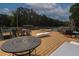 Expansive outdoor deck with waterfront views, lounge chairs, and comfortable seating areas perfect for entertaining at 6029 Shadburn Ferry Rd, Buford, GA 30518