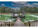 Enjoy lake views from private dock with boat lift, covered seating, and stairs to the water at 6029 Shadburn Ferry Rd, Buford, GA 30518