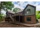 Charming home with a multi-level deck, wood and brick exterior, and mature trees at 6029 Shadburn Ferry Rd, Buford, GA 30518