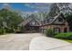 Charming brick home with a well-maintained lawn, a circular driveway, and mature trees at 6029 Shadburn Ferry Rd, Buford, GA 30518