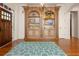 Inviting foyer with custom cabinetry, hardwood floors, and a decorative accent rug at 6029 Shadburn Ferry Rd, Buford, GA 30518