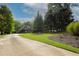 Beautifully landscaped front yard with well-manicured lawn and a long driveway leading to the home at 6029 Shadburn Ferry Rd, Buford, GA 30518