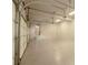 Large garage with epoxy flooring, bright lighting, and access to the interior of the home at 6029 Shadburn Ferry Rd, Buford, GA 30518