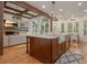 Bright kitchen with large island, granite countertops and hardwood floors, with an open view at 6029 Shadburn Ferry Rd, Buford, GA 30518