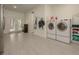 Bright laundry room with modern washer and dryer units, and access to the outdoors at 6029 Shadburn Ferry Rd, Buford, GA 30518
