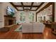 The living room features hardwood floors, a stone fireplace, coffered ceiling, and an open layout to the kitchen at 6029 Shadburn Ferry Rd, Buford, GA 30518
