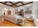 Spacious living room with a stone fireplace, coffered ceilings, custom built-ins, and lots of natural light at 6029 Shadburn Ferry Rd, Buford, GA 30518