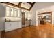 Open-concept living space features a well-stocked wet bar with modern white cabinetry and stainless appliances at 6029 Shadburn Ferry Rd, Buford, GA 30518