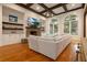 Inviting living room with stone fireplace, open shelves, bright arched windows, and coffered ceiling at 6029 Shadburn Ferry Rd, Buford, GA 30518