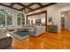 Open concept living room is bright and spacious, featuring hardwood floors and a large, comfortable sectional at 6029 Shadburn Ferry Rd, Buford, GA 30518