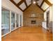 The spacious living room features a stone fireplace and expansive sliding doors to an outdoor living space at 6029 Shadburn Ferry Rd, Buford, GA 30518