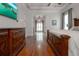 Spacious main bedroom featuring hardwood floors, a coffered ceiling, and a large dresser under a wall-mounted TV at 6029 Shadburn Ferry Rd, Buford, GA 30518