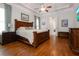 Spacious main bedroom features hardwood flooring, neutral paint, ceiling fan, and a large ensuite bath at 6029 Shadburn Ferry Rd, Buford, GA 30518