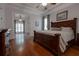 Spacious main bedroom features hardwood flooring, ceiling fan, and a sitting area off to the side at 6029 Shadburn Ferry Rd, Buford, GA 30518