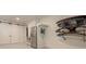 Functional mud room equipped with storage shelves, surfboard rack, and refrigerator at 6029 Shadburn Ferry Rd, Buford, GA 30518