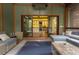 Cozy outdoor lounge area with access to an indoor kitchen, comfortable seating, and inviting ambiance at 6029 Shadburn Ferry Rd, Buford, GA 30518