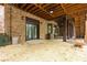 Brick patio featuring double doors, ceiling fan, and wooden benches, perfect for outdoor relaxation at 6029 Shadburn Ferry Rd, Buford, GA 30518