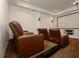 Home theater room with plush leather seating and a large projection screen at 6029 Shadburn Ferry Rd, Buford, GA 30518