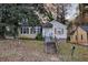 Quaint home features a cozy front yard with mature trees and a classic exterior, perfect for a starter home at 1347 Westmont Sw Rd, Atlanta, GA 30311