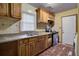 Functional kitchen features classic wood cabinets and basic appliances, awaiting your personal updates at 1347 Westmont Sw Rd, Atlanta, GA 30311