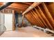 Spacious unfinished attic, revealing wooden rafters and brick wall, presenting opportunity for renovation at 238 15Th Ne St # 18, Atlanta, GA 30309