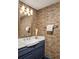 Stylish powder room with custom wallpaper, vessel sink, and a decorative gold-framed mirror at 238 15Th Ne St # 18, Atlanta, GA 30309