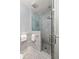 A modern bathroom features a large glass-enclosed shower, stone tile, and towel racks at 238 15Th Ne St # 18, Atlanta, GA 30309