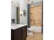Updated bathroom with granite vanity, integrated sink, bathtub with shower, and gray tile at 238 15Th Ne St # 18, Atlanta, GA 30309