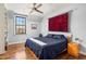Bedroom with hardwood floors, built-in bookshelf, and accent rug above bed at 238 15Th Ne St # 18, Atlanta, GA 30309
