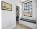 This organized walk-in closet has custom shelves and a bench with a window view at 238 15Th Ne St # 18, Atlanta, GA 30309