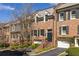 Brick townhouses showcasing manicured front yards and attached garages at 238 15Th Ne St # 18, Atlanta, GA 30309