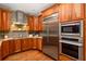 Kitchen with stainless steel appliances, wood cabinets, granite countertops, and decorative tile backsplash at 238 15Th Ne St # 18, Atlanta, GA 30309