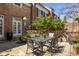Serene patio with dining set, brick accent wall, lush foliage, and privacy for outdoor enjoyment at 238 15Th Ne St # 18, Atlanta, GA 30309
