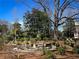 Inviting outdoor patio area with seating, perfect for relaxation and entertaining guests with lush greenery and mature trees at 238 15Th Ne St # 18, Atlanta, GA 30309