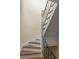 Elegant curved staircase with wood treads, white risers, and a classic black railing at 238 15Th Ne St # 18, Atlanta, GA 30309