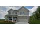 Charming two-story home featuring a gray exterior, brick accents, and an attached two-car garage at 6005 Spring Way, Stonecrest, GA 30038