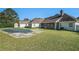 View of the home's exterior from the backyard, highlighting the in-ground pool and screened porch at 950 Sundew Se Dr, Conyers, GA 30013