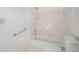 White bathroom featuring a shower-tub combo, grab bar, and hexagon tile flooring at 950 Sundew Se Dr, Conyers, GA 30013