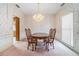 Classic dining room with a chandelier, wallpaper, and wooden table and chairs at 950 Sundew Se Dr, Conyers, GA 30013