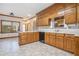 Traditional kitchen with wooden cabinets, white countertops, tile flooring, and a stainless-steel dishwasher at 950 Sundew Se Dr, Conyers, GA 30013