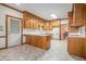 Classic kitchen with wooden cabinets, white countertops, and view to the breakfast nook and exterior door at 950 Sundew Se Dr, Conyers, GA 30013