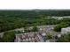 Aerial view of neighborhood with lush greenery, townhomes with solar panels, and Buckhead in the distance at 1049 Brandsford Nw St # 27-01, Atlanta, GA 30318