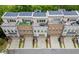 Aerial view of modern townhomes with solar panels and rooftop decks with seating and green space at 1049 Brandsford Nw St # 27-01, Atlanta, GA 30318