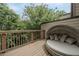 A private wood balcony features an outdoor daybed and wooded views, inviting you to relax at 1049 Brandsford Nw St # 27-01, Atlanta, GA 30318