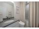 Well-lit bathroom featuring a sleek sink, toilet, and shower area with modern fixtures at 1049 Brandsford Nw St # 27-01, Atlanta, GA 30318