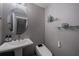 Elegant powder room with a pedestal sink, modern fixtures, designer mirror and a comfort height toilet at 1049 Brandsford Nw St # 27-01, Atlanta, GA 30318