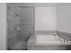 Modern bathroom featuring a tiled shower with glass door and a separate soaking tub at 1049 Brandsford Nw St # 27-01, Atlanta, GA 30318