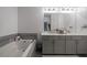 Modern bathroom with double vanity, soaking tub, and neutral color palette for a soothing ambiance at 1049 Brandsford Nw St # 27-01, Atlanta, GA 30318